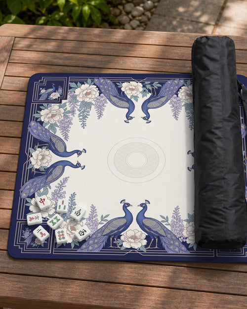Blue mahjong mat with a floral peacock border and an open center area for tile play.
