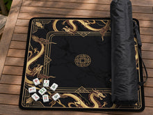 Square black mahjong mat with gold dragon artwork around the border and a light marble texture in the center.