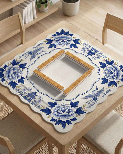 Blue and white mahjong mat with cranes, floral porcelain-style artwork, a cream center area, and a decorative border.