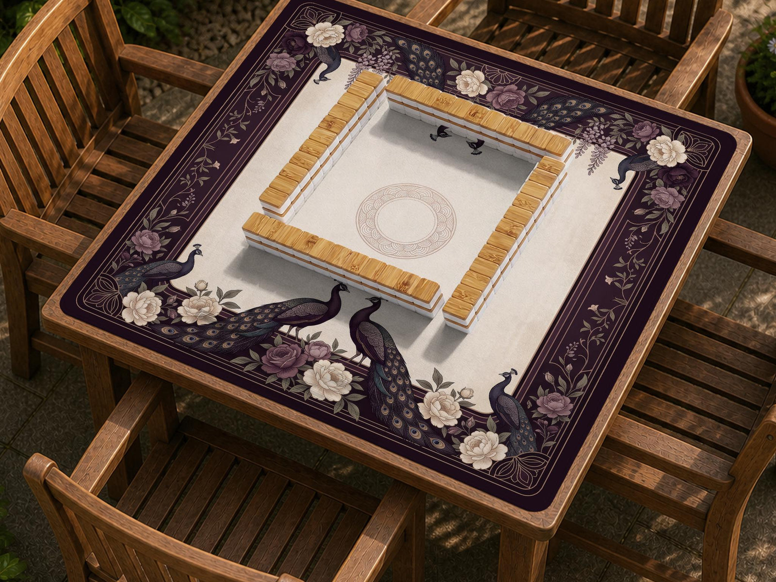 Square mahjong mat with a dark plum border, ivory floral pattern, muted sage leaves, and a decorative peacock garden design.