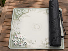 Square light green mahjong mat with bamboo stalks, soft ivory details, botanical shadows, mist lines, and a circular center design.