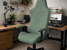 Sage green chair cover with a topographic contour-line pattern on a high-back gaming or office chair.