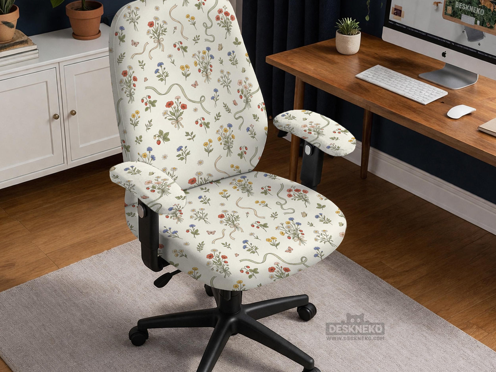 Cream chair cover with a scattered cottage garden floral print in red, blue, yellow, and green on a light background.