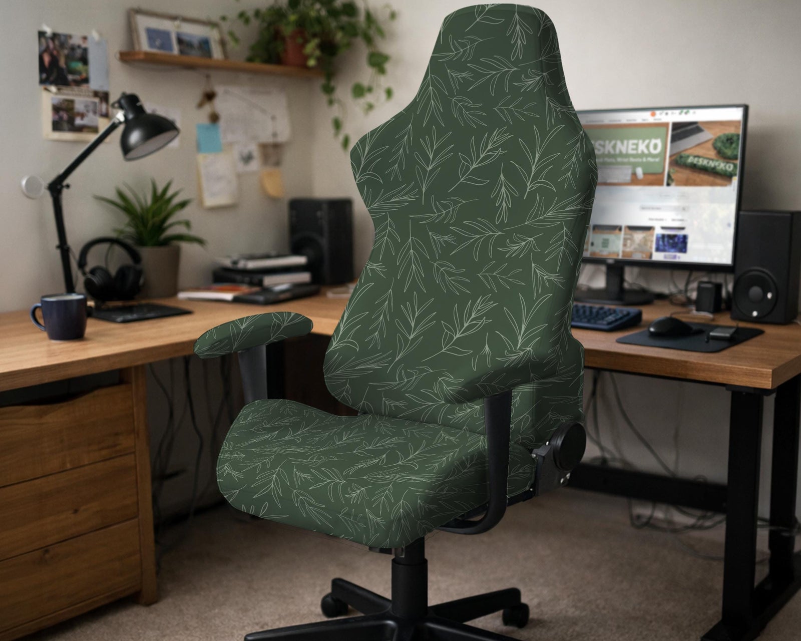 A forest green chair cover with a sage green leaf print shown on a high-back office or gaming chair.