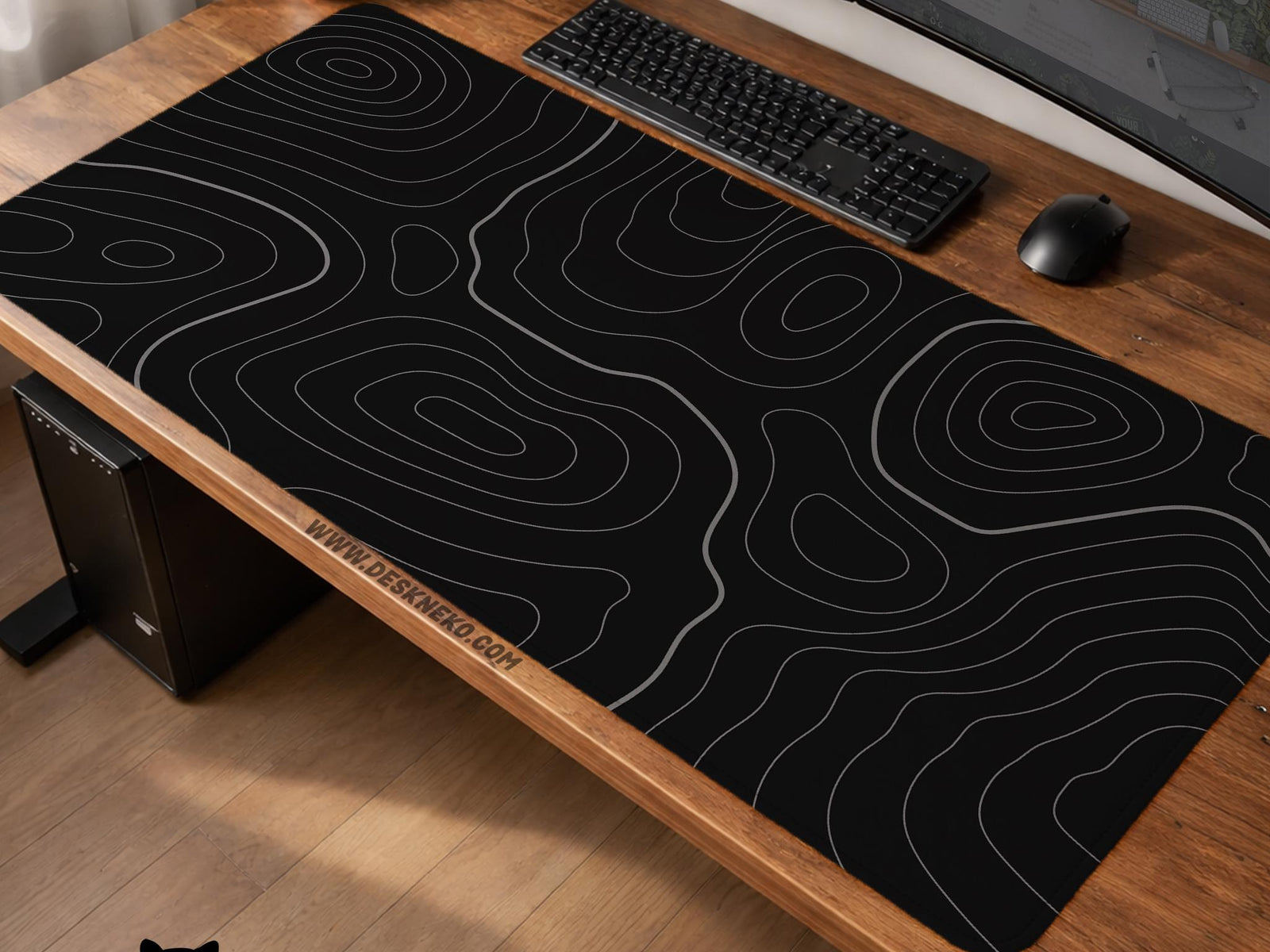 Black desk mat with a thin gray topographic contour line pattern.