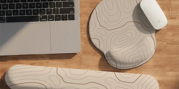 Beige mousepad and keyboard wrist rest with a topographic line pattern shown in a neutral desk setup.
