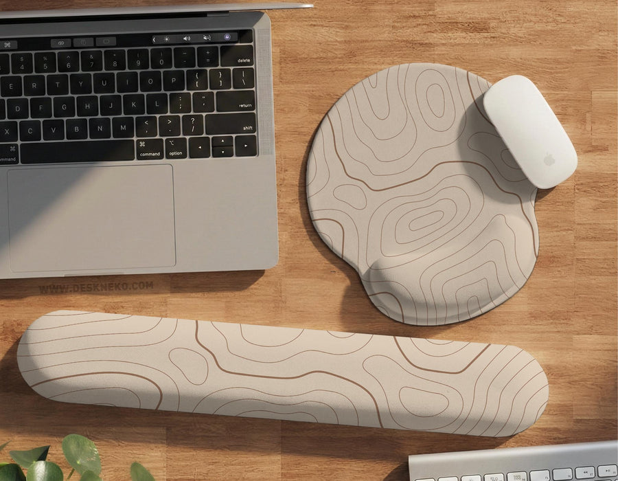 Beige mousepad and keyboard wrist rest with a topographic line pattern shown in a neutral desk setup.