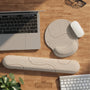 Beige mousepad and keyboard wrist rest with a topographic line pattern shown in a neutral desk setup.