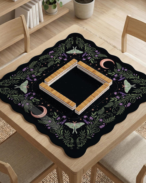 Black mahjong table mat with luna moths, purple flowers, soft green leaves, copper moons, and small star details.