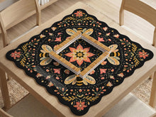 Black mahjong mat with a symmetrical botanical design, coral flowers, golden leaves, and small bees.