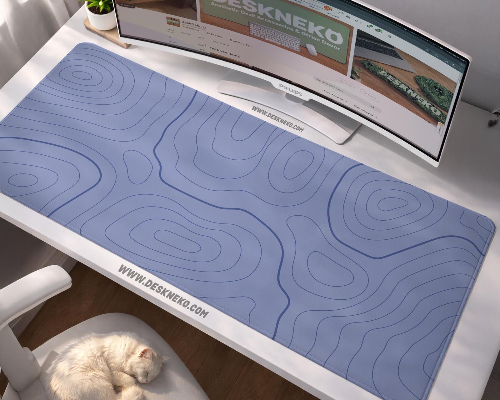 A periwinkle deskmat with thin blue contour lines printed across the surface.