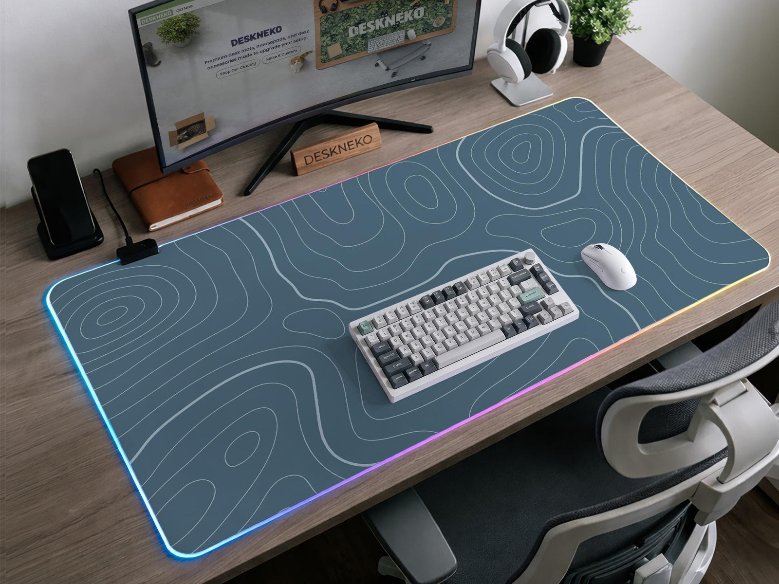 Blue mousepad with a topographic line pattern on a slate background.