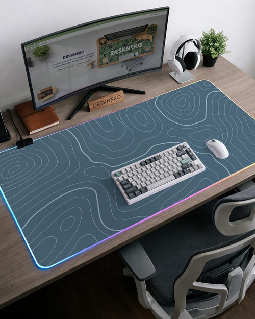 Blue mousepad with a topographic line pattern on a slate background.