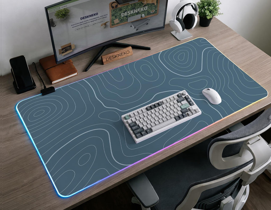 Blue mousepad with a topographic line pattern on a slate background.
