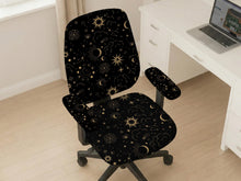 Black chair cover with gold moons, suns, stars, constellations, and line art printed across the fabric.