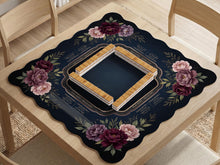 Burgundy mahjong mat with a floral border, gold botanical details, and printed American Mahjong rules on a dark background.