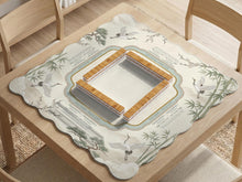 Sage green scalloped mahjong mat with bamboo, crane, and blossom illustration and printed rules around the border.