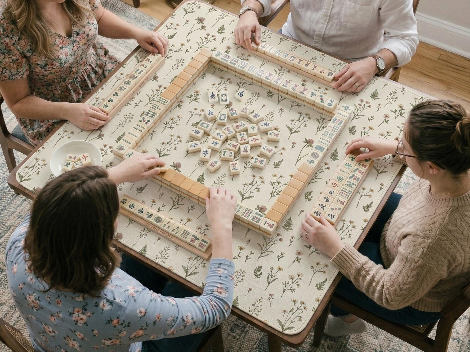 Cream mahjong mat with a delicate meadow flower pattern, soft beige background, and muted sage green leaves.