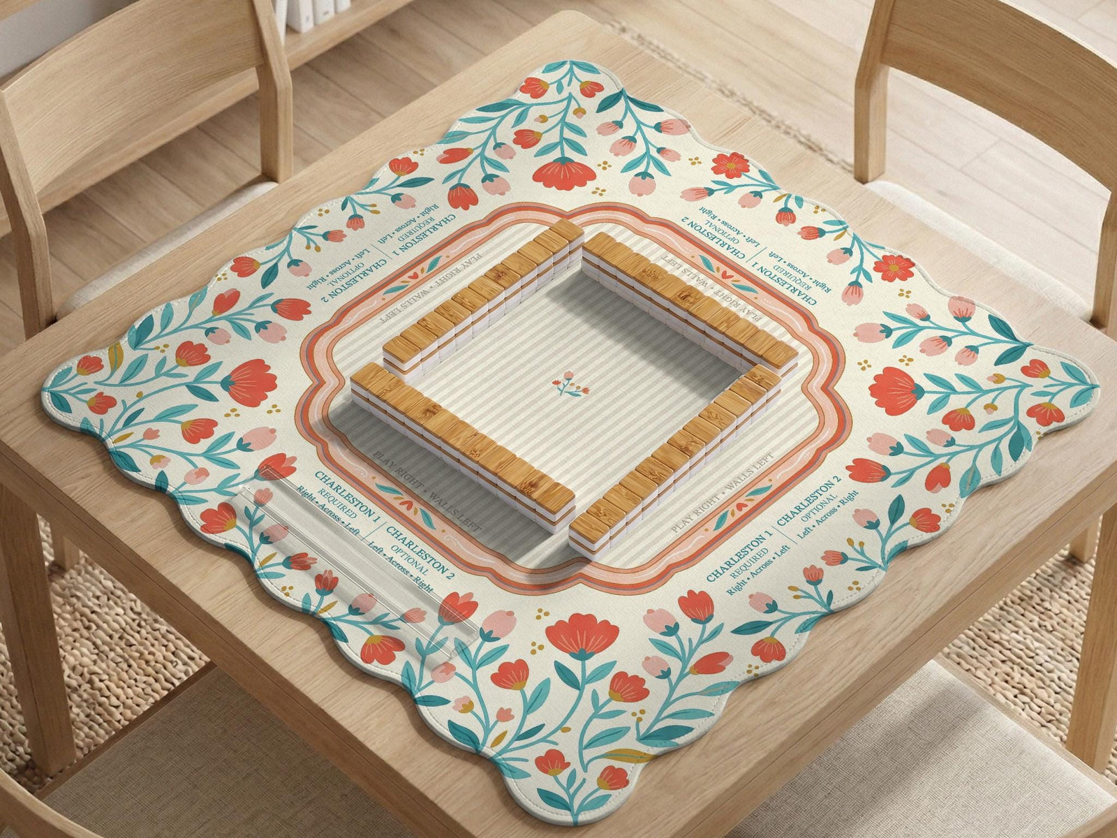 Cream square mahjong mat with coral flowers, teal stems, and a soft scalloped border.
