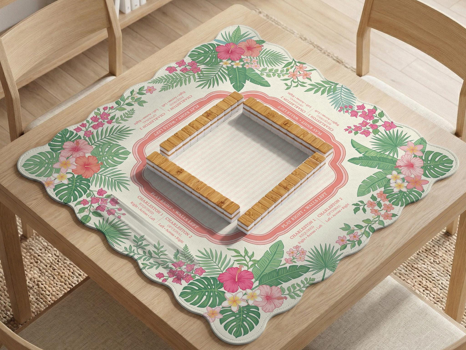 Coral tropical floral mahjong mat with hibiscus flowers, palm leaves, cream sections, and a scalloped edge.