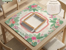 Green square mahjong mat with palm leaves, coral hibiscus flowers, cream rule areas, and printed game layout.