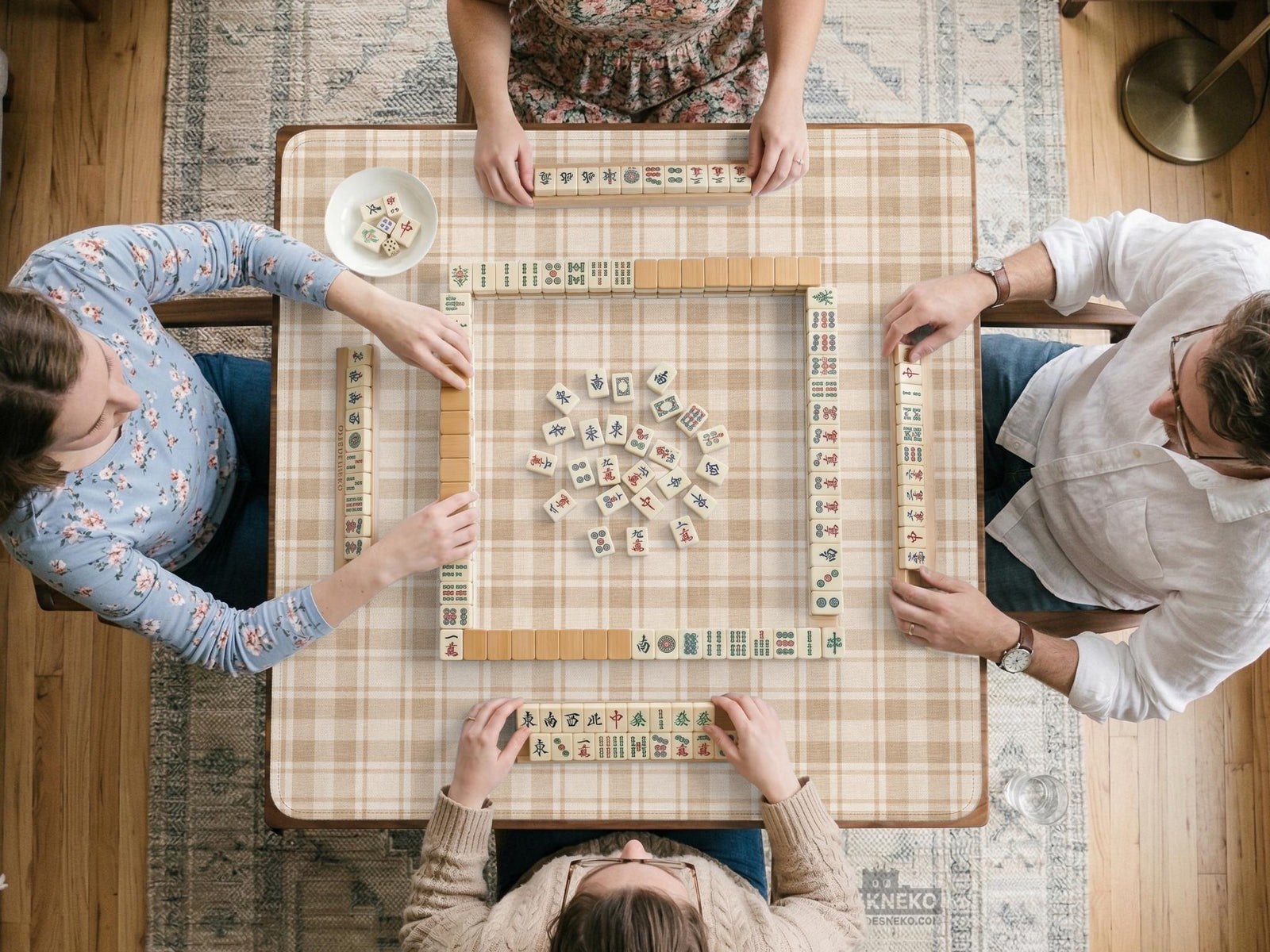 Beige and tan plaid square mahjong mat shown as a large table play surface.