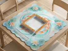Aqua square mahjong mat with orange koi fish, water lily flowers, lily pads, and flowing pond line artwork, shown with a scalloped edge.