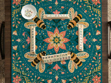 Green mahjong mat with a botanical bee and floral mandala design in teal, coral, cream, and gold.