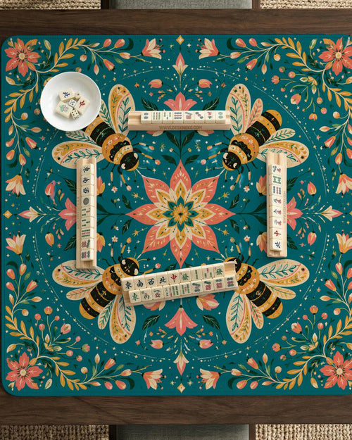 Green mahjong mat with a botanical bee and floral mandala design in teal, coral, cream, and gold.