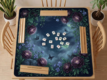 A square mahjong mat with a dark navy background, purple peonies, soft blue flowers, garden vines, butterflies, and small hidden cats around the border.