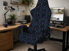Blue and black chair cover with a dragon scale print in teal, violet, navy, and copper tones.