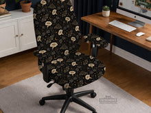 Black chair cover with a moth, moon, and flower pattern in gold, ivory, and dark botanical tones.