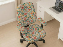 Cream desk chair cover with a vintage floral print featuring coral roses, mustard daisies, and green vines on a chair.