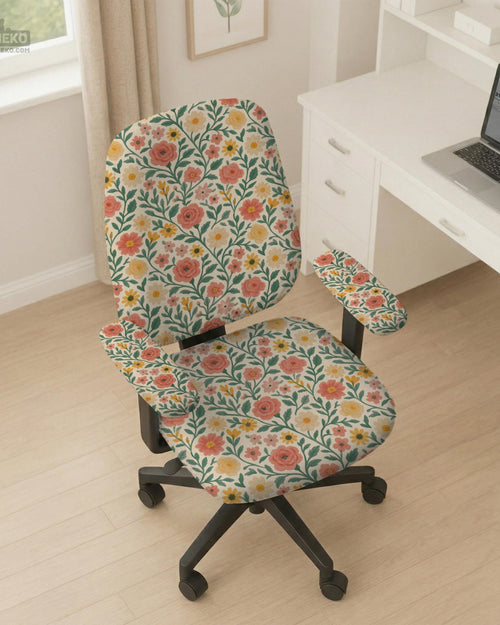 Cream desk chair cover with a vintage floral print featuring coral roses, mustard daisies, and green vines on a chair.