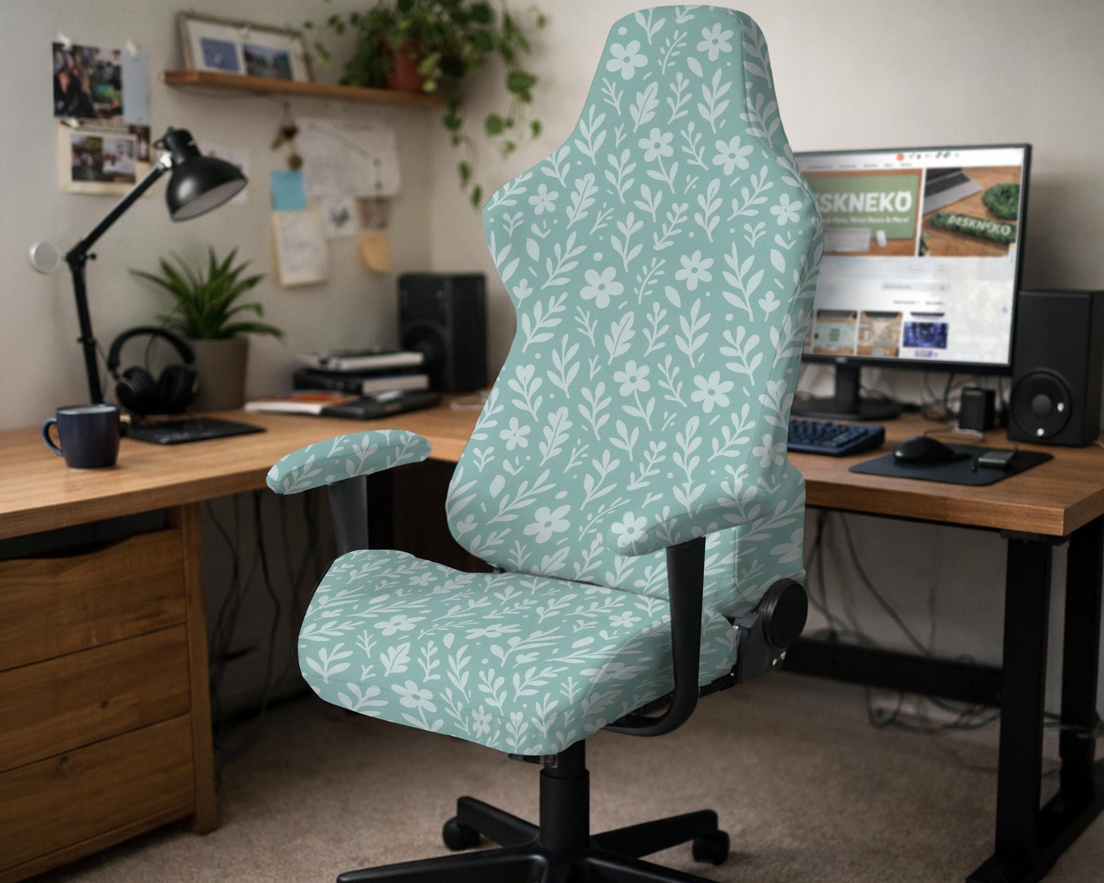 Sage and aqua green floral chair cover shown on a gaming chair with matching armrest covers.