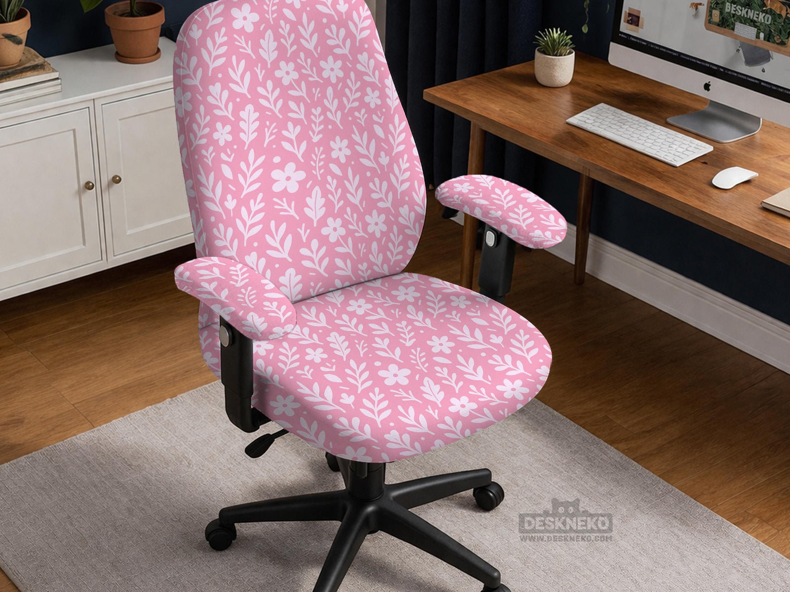 Blush pink chair cover with a small botanical floral pattern shown on an office chair.