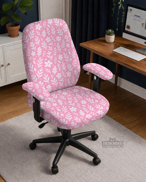 Blush pink chair cover with a small botanical floral pattern shown on an office chair.