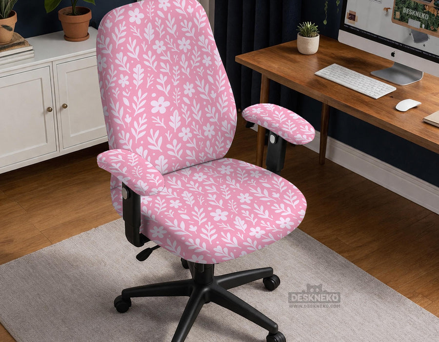 Blush pink chair cover with a small botanical floral pattern shown on an office chair.
