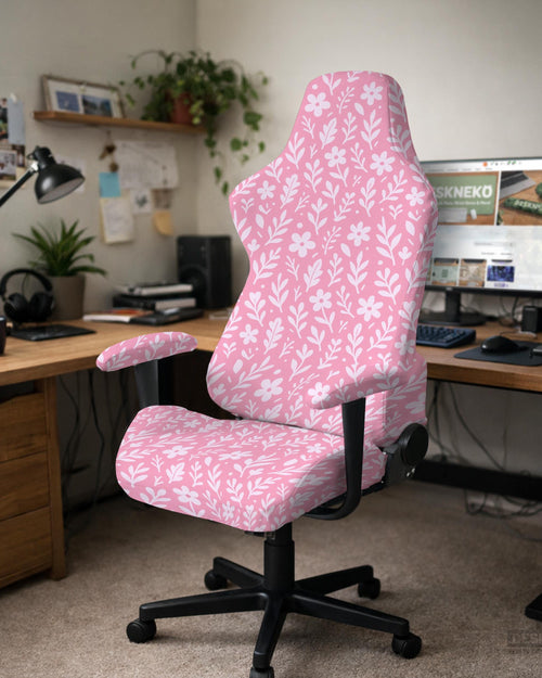 Soft pink floral chair cover shown on a gaming chair with a high back and armrests.
