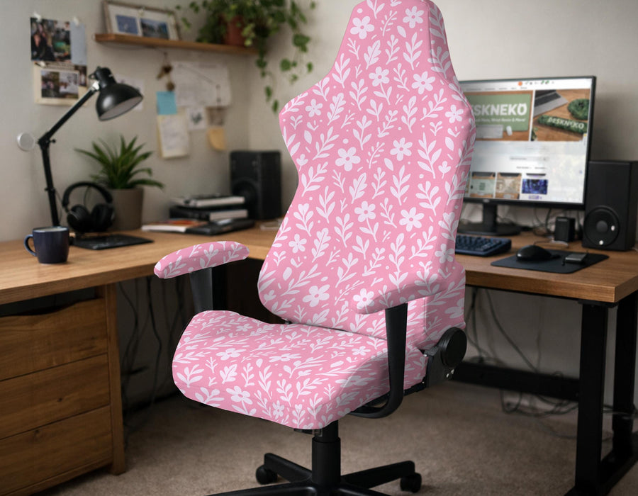 Soft pink floral chair cover shown on a gaming chair with a high back and armrests.