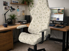 An ivory chair cover set with a subtle vine pattern shown on a black gaming chair, including cover options for the chair back, seat, and armrests.