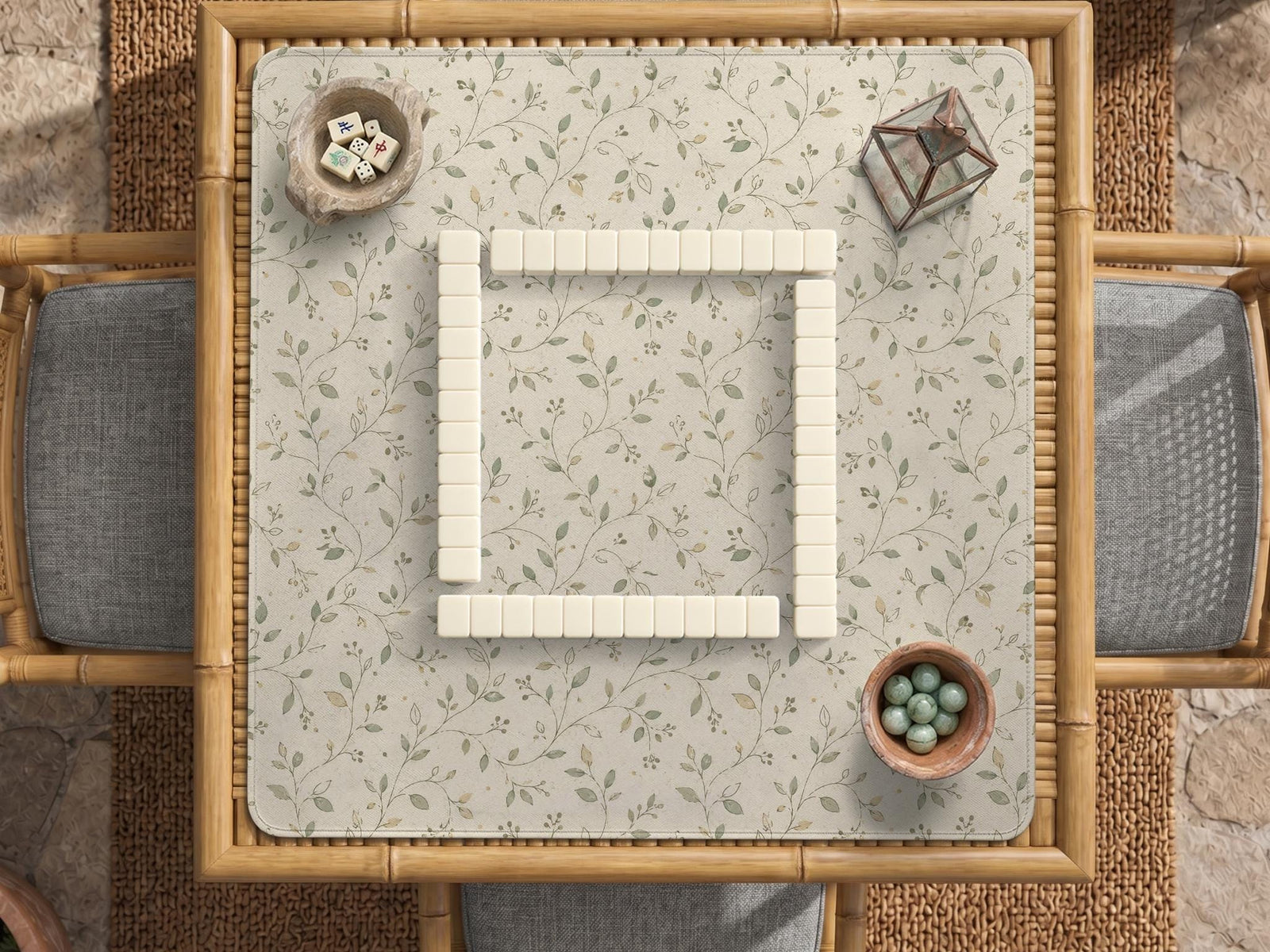 Sage green botanical mahjong mat with a cream background, trailing vines, and muted leaf designs.