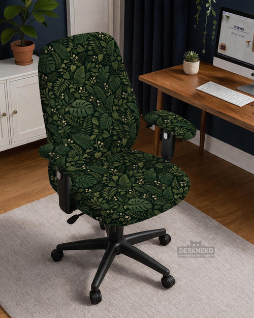 Forest green chair cover with a tropical leaf pattern featuring monstera leaves and small cream flowers.