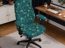 Blue green chair cover with a peacock feather pattern shown on an office chair, with fitted stretch fabric and armrest coverage visible in the listing image.