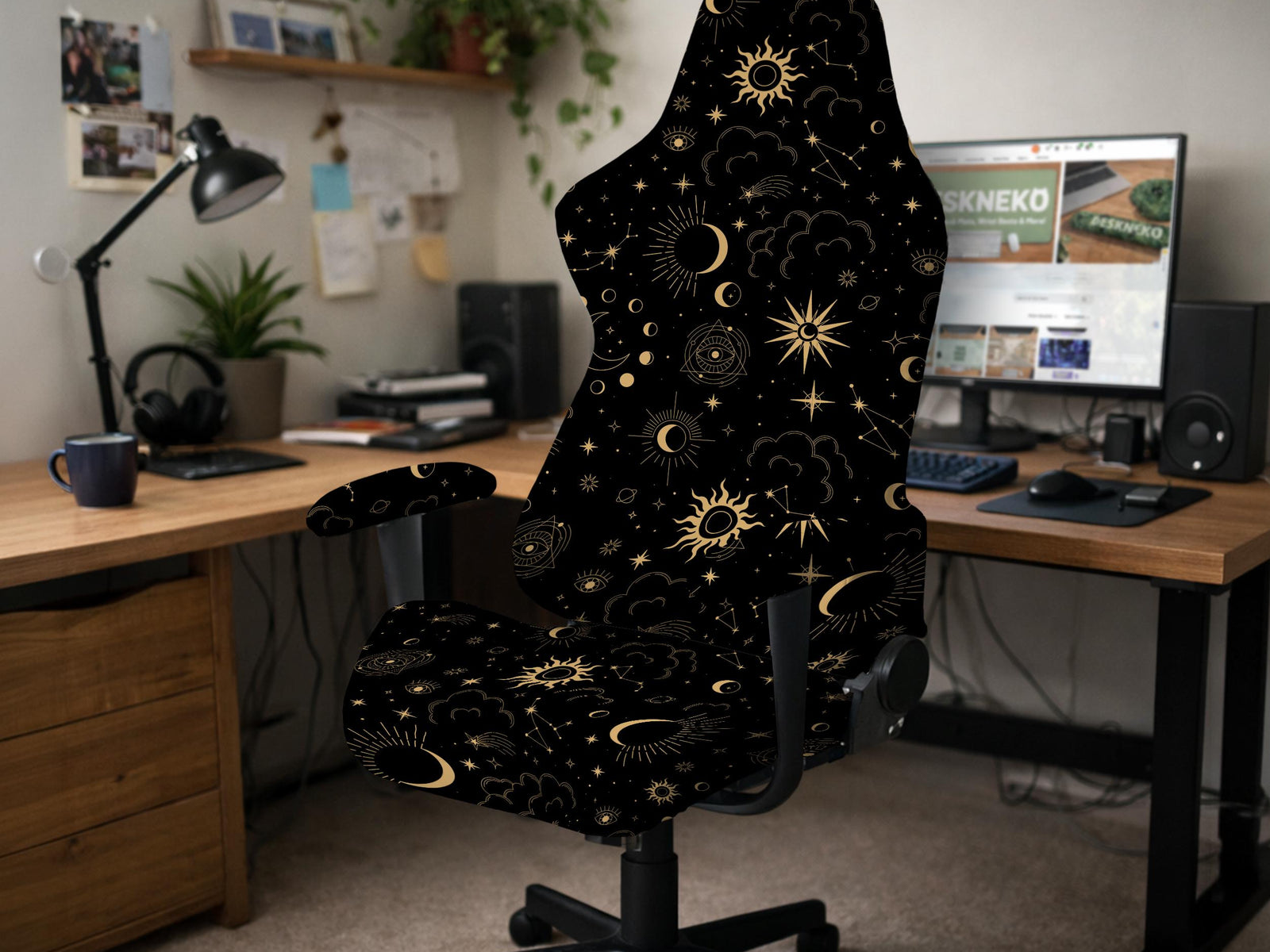 Black chair cover with a gold astrology print of moons, suns, stars, and symbols on a gaming chair.