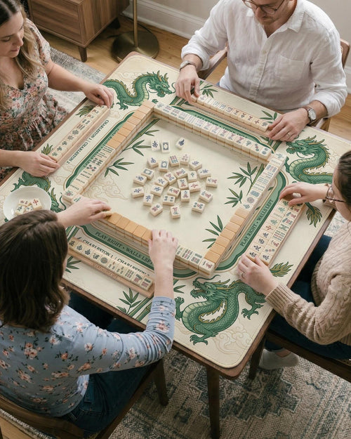 Ivory square mahjong mat with green dragon illustrations, bamboo stalks, clouds, a lotus center, and printed rules around the border.