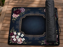 A square mahjong mat with peony flowers and printed American mahjong instructions around the edges.
