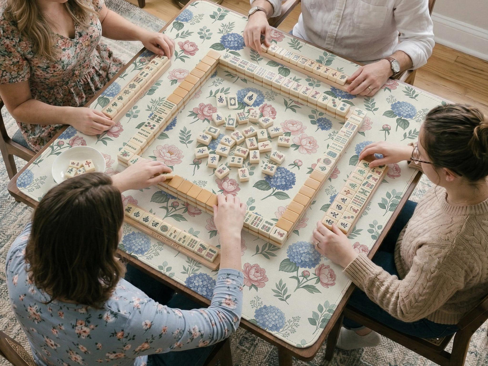 Blue mahjong mat with a peony and hydrangea floral pattern in soft blue, pink, ivory, and sage green.