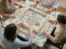 Blue mahjong mat with a peony and hydrangea floral pattern in soft blue, pink, ivory, and sage green.