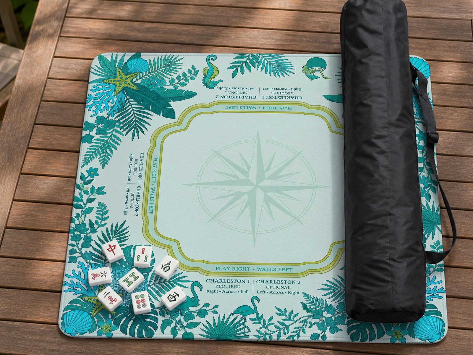Aqua square mahjong mat with a botanical border and printed American Mahjong rule layout, including Charleston reminders and tile reference details.